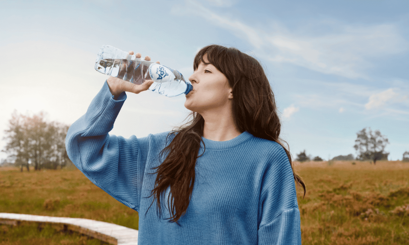 Vrouw drinkt SPA® Reine